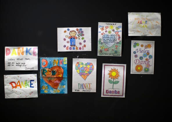 Düsseldorf, Deutschland, Kinderzeichnungen hängen im Eingangsbereich des REWE-Markt Yade in Düsseldorf am 24.03.2020