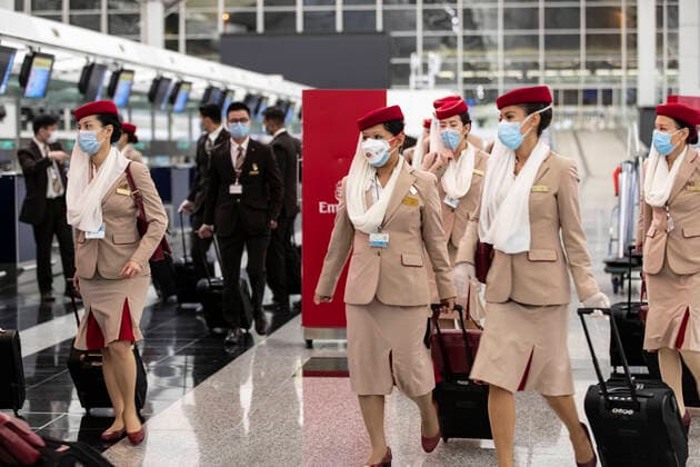 March 24, 2020, Hong Kong, China: Crew members from Emirates airline are seen leaving Hong Kong international airport..Temporally 14 days new measures in response to the latest situation of COVID-19 started on March 25, 2020, including compulsory quarantine for HK residents; Stop entry for non-Hong Kong residents from overseas and suspend all transit services along with limited service provided from the airport shops and restaurants. Hong Kong China - ZUMAs197 20200324_zaa_s197_161 Copyright: xMayxJamesx