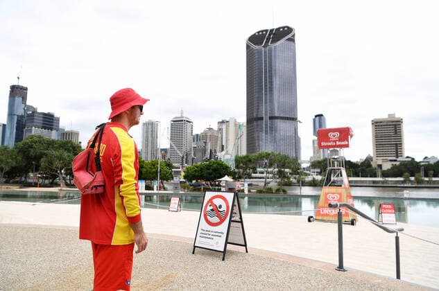 AUSTRALIA CORONAVIRUS COVID-19, A lifeguard patrols the parameter of South Bank beach which has been closed to the public in Brisbane, Wednesday, March 25, 2020. A shutdown of non-essential services as well as domestic and international travel restrictions are in effect Australia wide in a bid to slow the spread of the COVID-19 coronavirus. ( NO ARCHIVING, EDITORIAL USE ONLY, NO USE IN BOOKS WITHOUT CONSENT BRISBANE QUEENSLAND AUSTRALIA  Copyright: xDANxPELEDx 20200325001459302965