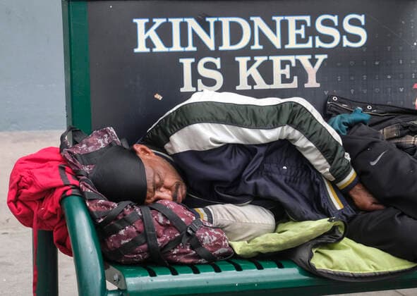 March 24, 2020, Los Angeles, California, U.S: A man rests on a bench in downtown Los Angeles on Tuesday, March 24, 2020. California Gov. Gavin Newsom issued a statewide stay-at-home order Thursday for residents to venture outside only for essential jobs, errands and some exercise, due to coronavirus concerns. Los Angeles U.S. - ZUMAc68_ 20200324_zaf_c68_014 Copyright: xRingoxChiux
