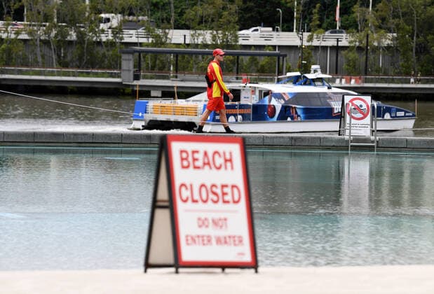 AUSTRALIA CORONAVIRUS COVID-19, A lifeguard patrols the parameter of South Bank beach which has been closed to the public in Brisbane, Wednesday, March 25, 2020. A shutdown of non-essential services as well as domestic and international travel restrictions are in effect Australia wide in a bid to slow the spread of the COVID-19 coronavirus. ( NO ARCHIVING, EDITORIAL USE ONLY, NO USE IN BOOKS WITHOUT CONSENT BRISBANE QUEENSLAND AUSTRALIA  Copyright: xDANxPELEDx 20200325001459414760