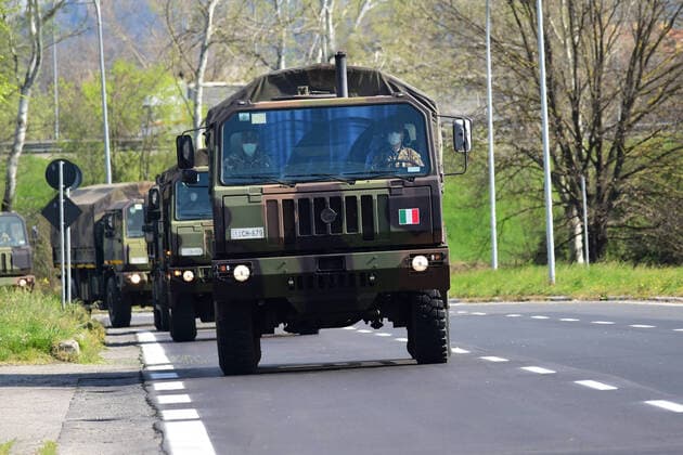(200324) -- BOLOGNA (ITALY), March 24, 2020 (Xinhua) -- Military trucks carry bodies of patients who died from COVID-19 infections from Bergamo to Bologna, Italy, on March 24, 2020. The COVID-19 pandemic has claimed 6,820 lives in locked-down Italy by Tuesday with the cumulative number of cases reaching 69,176, according to new data released by the Civil Protection Department. (Photo by Gianni Schicchi Xinhua) ITALY-BOLOGNA-COVID-19-DEATH 