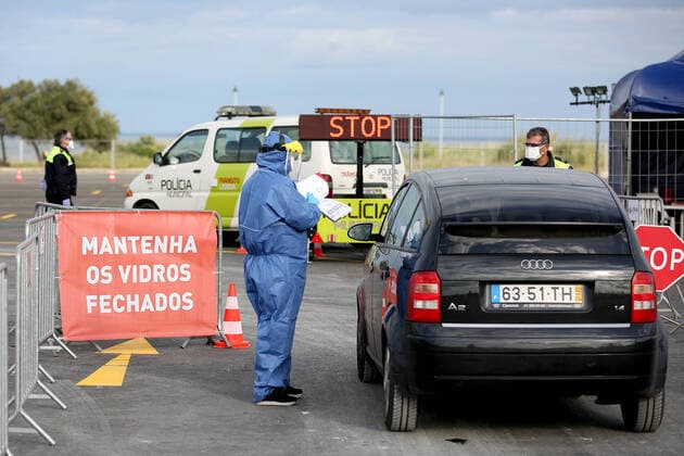 (200325) -- LISBON, March 25, 2020 -- A medical worker works at a COVID-19 drive-through screening center in Lisbon, Portugal, on March 24, 2020. COVID-19, caused by the novel coronavirus, has infected 2,362 people and killed 33 in Portugal, according to the latest from the health authorities. (Photo by Xinhua) PORTUGAL-LISBON-DRIVE THROUGH-SCREENING CENTER PedroxFiuza 