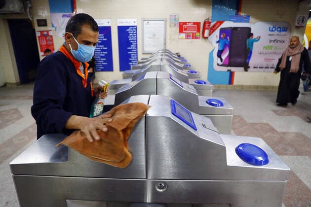 (200325) -- CAIRO, March 25, 2020 -- A man cleans a turnstile in a metro station in Cairo, Egypt on March 24, 2020. Egypt announced on Tuesday that one COVID-19 case died and 36 new cases were detected, bringing the total number of cases in the country to 402. Ahmed Gomaa) EGYPT-CAIRO-METRO-COVID-19-MEASURES WuxHuiwo 