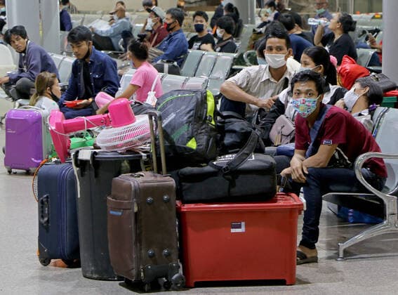 March 25, 2020, Bangkok, Thailand: Migrant workers sit as they wait to leave from city at Bus Terminal in Bangkok on March 25, 2020. The government will declare an emergency and introduce new measures to combat the coronavirus disease 2019 (Covid-19) on Thursday26 March 2020, Prime Minister Prayut Chan-o-cha said. Bangkok Thailand - ZUMAu103 20200325_zia_u103_004 Copyright: xUrdeexImagex