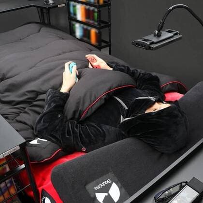 March 25, 2020: A Japanese furniture company have created the perfect coronavirus lockdown set-up with a gaming bed that has room for food and drinks...Video game addicts can now play, eat, drink and nap all without ever leaving their bed...The Ã‚Â£450 gaming bed by Bauhutte means gamers can play non-stop without having to leave for interruptions like eating or sleeping - only the call of nature might lure them away as the bed does not currently feature a bathroom... I wake up and move from my bed to my desk. Why is that so complicated? gaming furniture outfit Bauhutte says in promotions for the bed on its website... Gaming beds solve this problem. ..The bed comes with a desk that can support video screens, an elevating headboard and a headphone hanger...A metallic arm attached to the bed can mount a tablet screen above a person s fa - ZUMAc218 20200325_zia_c218_007 Copyright: xCOVERxImagesx