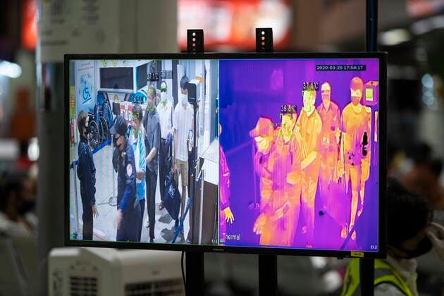 March 25, 2020, Bangkok, Bangkok, Thailand: Passengers walk past a thermal imaging camera put in place to detect possible symptoms of the Covid-19 virus at the entrance to Bangkok s Mochit Bus Terminal. Prime Minister Prayut Chan-O-Cha declared that starting at midnight March 26, 2020 Thailand would institute the most comprehensive lockdown procedures so far to combat the spread of Covid-19. For the third day in a row crowds of passengers gathered at Bangkok s Mochit Bus Terminal to leave the city, many making the decision to leave the Thai capital due to the mass closure of businesses causing financial burden on the city s economically insecure workforce. Bangkok Thailand - ZUMAt128 20200325_zap_t128_005 Copyright: xAdryelxTalamantesx