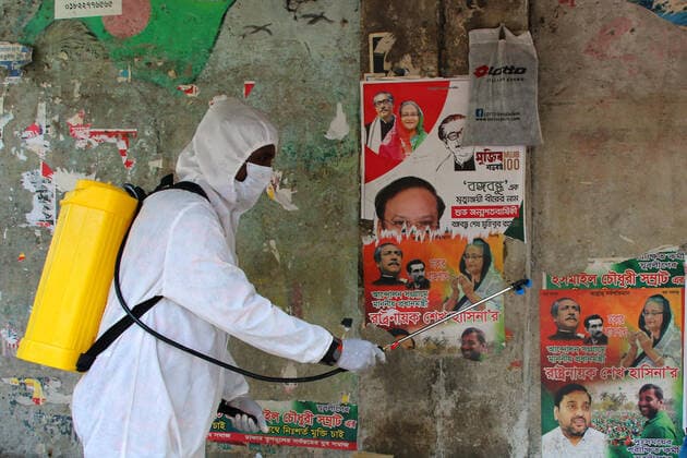March 26, 2020, Dhaka, Bangladesh: A Fire bridge member wearing a protective suite sprays disinfectant on a wall amid concerns about the spread of coronavirus disease (COVID-19) in Dhaka..Death toll raised to 5 and 39 people were reported infected by COVID-19 in Bangladesh. Dhaka Bangladesh - ZUMAs197 20200326_zaa_s197_016 Copyright: xSultanxMahmudxMukutx