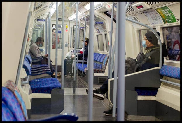 . 25 03 2020. London, United Kingdom. Ongoing Coronavirus Crisis. Three passengers wearing face masks sit apart exercising social isolation on the Jubilee Line during the Coronavirus crisis.  xMartynxWheatleyx xi-Imagesx IIM-20954-0002