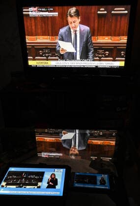 The italian Prime Minister Giuseppe Conte is seen on television, tablet and mobile phone, during his speech at the the lower chamber about the measures taken to counter the spread of the Coronavirus in Italy . Roma 25 03 2020 Photo Andrea Staccioli Insidefoto andreaxstaccioli