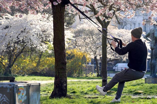 25.03.2020, Berlin - Deutschland. Sport im Freien während der Corona-Krise bei schönem Wetter. Die Sonne scheint und die Bäume stehen in voller Blüte.
