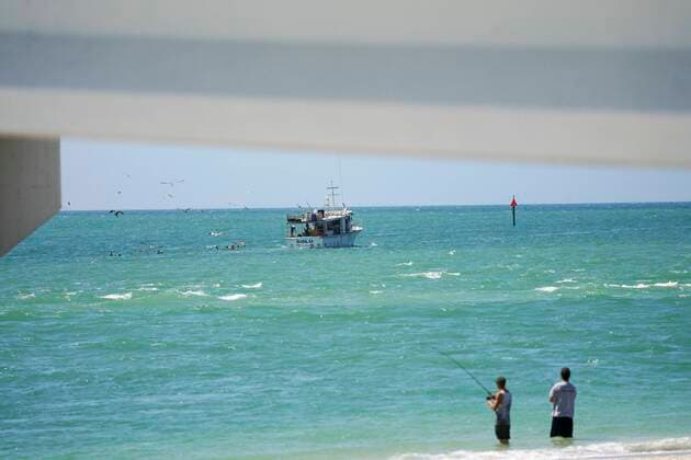 March 25, 2020, Madeira Beach, Florida, USA: A fishing boat and a pair of fishermen are pictured at John s Pass on Wednesday, March 25, 2020 in Madeira Beach. Madeira Beach USA - ZUMAs70_ 20200325_zan_s70_095 Copyright: xMarthaxAsencioxRhinex