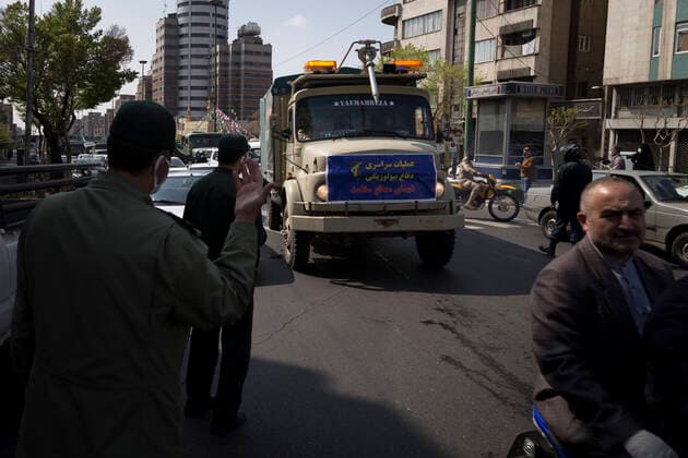March 25, 2020, Tehran, Iran: Iran s Revolutionary Guard Corps carry out disinfection works as a preventive measure against the coronavirus (Covid-19) pandemic as part of the biological defense drill, launched in coordination with the National Headquarters For Fighting The Coronavirus, in 100 different points in Tehran, Iran. Iran launched the 3-day biological defense drill at 3,000 locations across the country. A total of 143 people in Iran have died of coronavirus over the last 24 hours, pushing the death toll up to 2,077, said Iranian health authorities on Wednesday. Italy, China, Iran, and Spain continue to be the most affected countries. Tehran Iran - ZUMAf146 20200325_zip_f146_035 Copyright: xRouzbehxFouladix