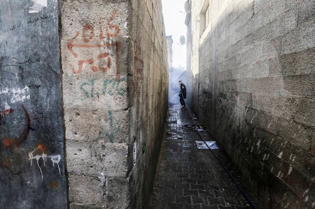 March 25, 2020, Gaza City, The Gaza Strip, Palestine: A Palestinian sprays disinfectant as a precaution against the spread of the Covid-19 coronavirus, in the streets of the Jabalia refugee camp, northern Gaza Strip, 25 March 2020. The Palestinian Ministry of Health in Gaza had confirmed on 22 March 2020 that there were two cases of novel coronavirus Covid-19 in the Gaza Strip. Gaza City Palestine - ZUMAq100 20200325_zaa_q100_042 Copyright: xMahmoudxIssax