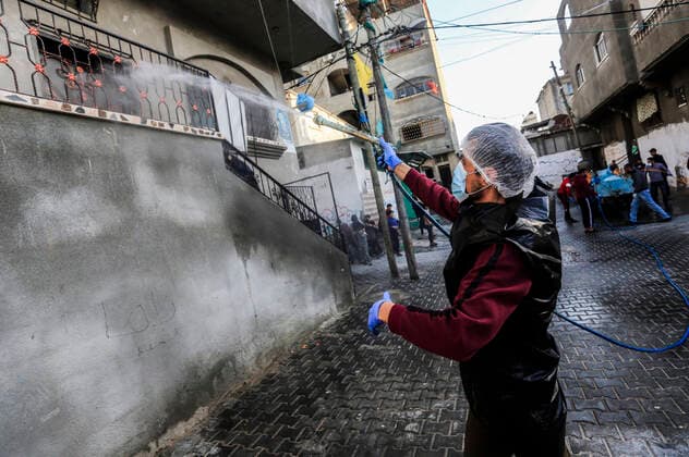 March 25, 2020, Gaza City, The Gaza Strip, Palestine: A Palestinian sprays disinfectant as a precaution against the spread of the Covid-19 coronavirus, in the streets of the Jabalia refugee camp, northern Gaza Strip, 25 March 2020. The Palestinian Ministry of Health in Gaza had confirmed on 22 March 2020 that there were two cases of novel coronavirus Covid-19 in the Gaza Strip. Gaza City Palestine - ZUMAq100 20200325_zaa_q100_056 Copyright: xMahmoudxIssax
