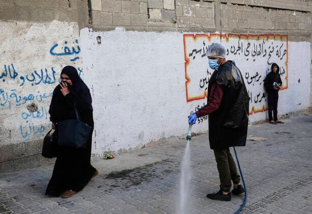 March 25, 2020, Gaza City, The Gaza Strip, Palestine: A Palestinian sprays disinfectant as a precaution against the spread of the Covid-19 coronavirus, in the streets of the Jabalia refugee camp, northern Gaza Strip, 25 March 2020. The Palestinian Ministry of Health in Gaza had confirmed on 22 March 2020 that there were two cases of novel coronavirus Covid-19 in the Gaza Strip. Gaza City Palestine - ZUMAq100 20200325_zaa_q100_062 Copyright: xMahmoudxIssax