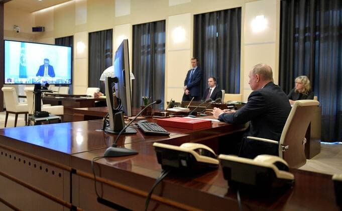 March 26, 2020. - Russia, Moscow Region, Novo-Ogaryovo. - Russian President Vladimir Putin (right) takes part in an extraordinary G20 Summit via a video link. The summit is dedicated to the COVID-19 coronavirus pandemic and is held online for the first time. KremlinxPool