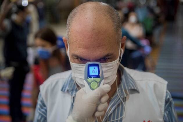 A health worker takes the temperature of European citizens who will take a flight to Madrid, at the Simon Bolivar International Airport in Maiquetia, in La Guaira, Caracas, Venezuela, 26 March 2020. Gianmarco Romeo preferred that his father return to his native Italy: He came to see me; he had not seen him for a year and a half. He has to leave because he is diabetic and here he does not get medicines. After two weeks with the Venezuelan airspace closed by the COVID-19 pandemic, this Thursday he was able to travel on a flight chartered by the Spanish Embassy. Europeans from various countries leave Venezuela thanks to Spain !ACHTUNG: NUR REDAKTIONELLE NUTZUNG!  Copyright: xRAYNERxPENAxR.x AME8204 20200327-637208675027428139