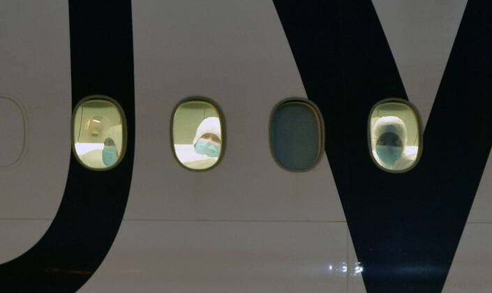 (200327) -- BEIJING, March 27, 2020 -- Kuwaiti citizens evacuated from abroad are seen inside a plane at Kuwait International Airport in Farwaniya Governorate, Kuwait, on March 26, 2020. (Photo by Xinhua) XINHUA PHOTOS OF THE DAY Asad 
