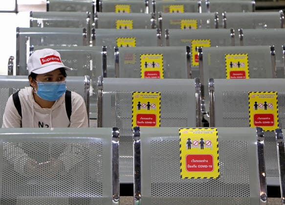 March 27, 2020, Bangkok, Thailand: Passenger looks on while sits next at chairs with stickers to keep social distancing to stop the spread of Coronavirus Covid-19 at bus terminal in Bangkok on March 27, 2020. Globally, the virus has now infected more than 532,670 people and killed at least 24,092. Bangkok Thailand - ZUMAu103 20200327_zia_u103_002 Copyright: xUrdeexImagex