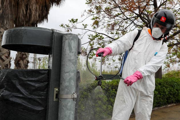 March 27, 2020, Valencia, VALENCIA, SPAIN: Illustration, Operator disinfects urban furniture protected with mask, gloves and suit. during the thirteenth day after the Government declared the state of alarm in Spain and recommended people to stay at home to fight coronavirus COVID-19 on March 27, 2020 in Valencia, Spain Valencia SPAIN - ZUMAa181 20200327_zaa_a181_079 Copyright: xIvanxTerronx