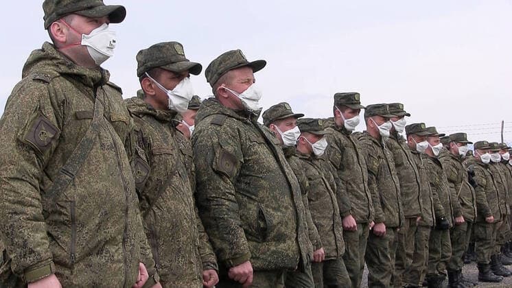 BERGAMO, ITALY - MARCH 27, 2020: Pictured in this video grab are Russian military officers in respirators at an Italian Air Force base, on the outskirts of Bergamo in Alpine Lombardy, one of the worst hit regions of Italy during the pandemic of the novel coronavirus (COVID-19). Russia has sent more than 100 military virologists, epidemiologists and CBRN specialists to Italy to help battle the pandemic. Russian military specialists are involved in sanitising and disinfecting healthcare facilities, urban infrastructure, and vehicles. Video grab. Defence Ministry of the Russian Federation TASS  TS0D38D2