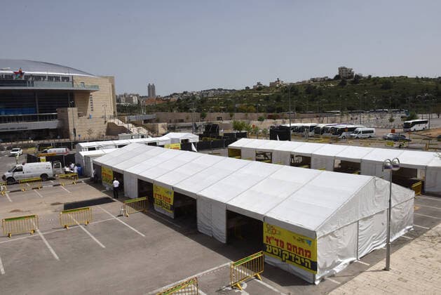 An overview of a coronavirus drive through facility in Jerusalem, on Friday, March 27, 2020. Eleven Israelis have died from the coronavirus, while more than 3,000 have been diagnosed with the disease. The Israeli government has imposed tight restrictions of movement, leaving only essential stores open in an effort to stop the spread of the coronavirus.  JER2020032711 DEBBIExHILL