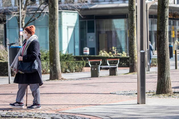 27.03.2020, DU Duisburg , Corona legt Stadtmitte Duisburg lahm , Menschen mit Mundschutz unterwegs , Obdachlose in Gruppen unterwegs , Polizei kontrolliert. Eine ältere Dame mit Mundschutz in der Innenstadt unterwegs.