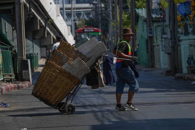 March 27, 2020, Bangkok, Thailand: A street cleaner crossing the street with out a face mask during the coronavirus (Covid-19) pandemic..Thai government imposed a state of emergency decree that started on March 26, 2020 for the tackle to coronavirus (Covid-19) pandemic. On March 27, 2020 Thai public health ministry reported 91 new cases patients of coronavirus (Covid-19), raising the total to 1,136 and 5 deaths. Bangkok Thailand - ZUMAs197 20200327_zaa_s197_039 Copyright: xVachiraxKalongx