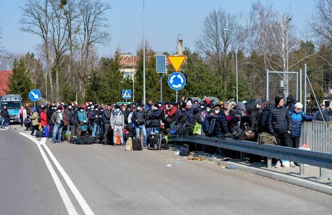 Large crowd of Ukrainian citizens is waiting to cross the border and return home at the Polish-Ukrainian crossing border in Korczowa Large crowd of Ukrainian citizens is waiting to cross the border and return home at the Polish-Ukrainian crossing border on March 27, 2020 in Korczowa, Poland EN_01422104_0005 