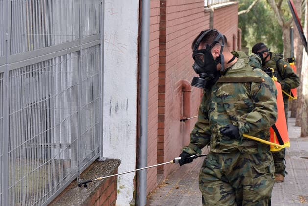 March 27, 2020, LÂ Hospitalet, Barcelona, Spain: Spanish Army officer wearing a protective mask as a preventive measure, doing disinfection work during the corona virus pandemic..The Spanish Army is collaborating in this health crisis of the Coronavirus Covid-19 in different cities of Spain. In the city of LÂ Hospitalet the Motorized Infantry Battalion 1 63 has carried out the disinfection of different streets and neighbourhoods. LÂ Hospitalet Spain - ZUMAs197 20200327_zaa_s197_076 Copyright: xRamonxCostax