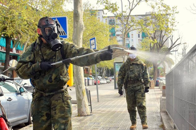March 27, 2020, LÂ Hospitalet, Barcelona, Spain: Spanish Army officer wearing a protective mask as a preventive measure, doing disinfection work during the corona virus pandemic..The Spanish Army is collaborating in this health crisis of the Coronavirus Covid-19 in different cities of Spain. In the city of LÂ Hospitalet the Motorized Infantry Battalion 1 63 has carried out the disinfection of different streets and neighbourhoods. LÂ Hospitalet Spain - ZUMAs197 20200327_zaa_s197_080 Copyright: xRamonxCostax
