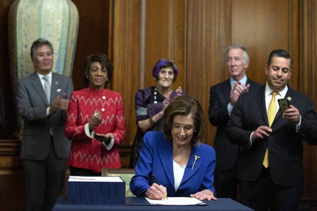 Speaker of the House Nancy Pelosi signs the $2.2 trillion CARES Act at the U.S. Capitol on Friday, March 27, 2020 in Washington, D.C. The stimulus bill, the largest in U.S history, provides economic bailouts to companies, independent contractors and includes direct payments to individuals as the U.S. suffers from the COVID-19 pandemic.  WAP202003278026 STEFANIxREYNOLDS