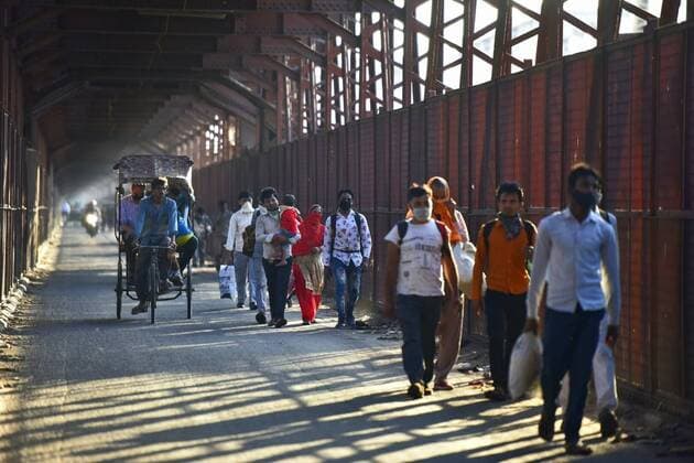 NEW DELHI, INDIA - MARCH 27: Migrant workers leave for their hometowns and villages on foot owing to public transport being suspended, on day 3 of the three week nationwide lockdown to check the spread of Coronavirus COVID-19 , at Iron Bridge on March 27, 2020 in New Delhi, India. (Photo by Sonu Mehta Hindustan Times) Hit By Lockdown, Migrant Workers Walk To Reach Homes