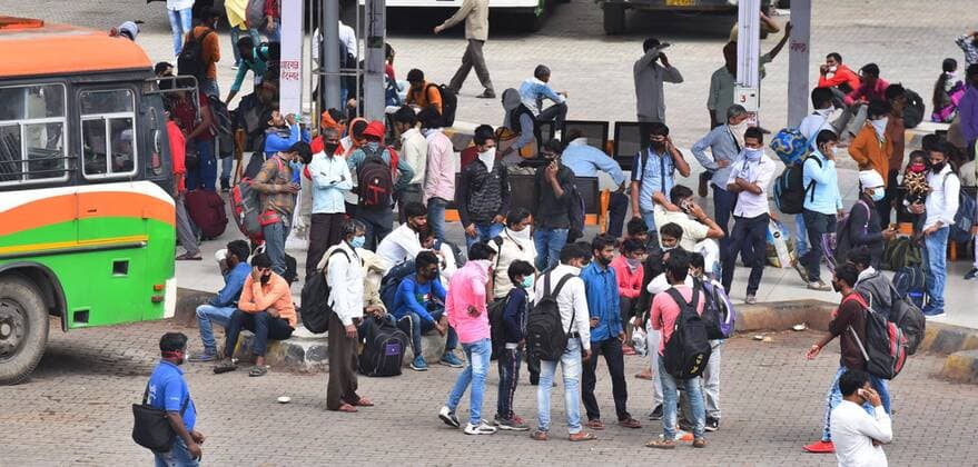 NEW DELHI, INDIA - MARCH 27: Migrant workers are seen waiting for public transport to head to their homes on the third day of the national lockdown imposed by Prime Minister Narendra Modi to curb the spread of Coronavirus COVID-19 , at Anand Vihar bus terminal, on March 27, 2020 in New Delhi, India. (Photo by Raj K Raj Hindustan Times) Hit By Lockdown, Migrant Workers Walk To Reach Homes