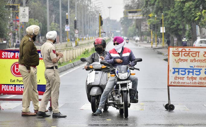 AMRTISAR, INDIA - MARCH 27: Police personnel stop motorists at Novelty Chowk, on day 3 of the three week nationwide lockdown to check the spread of Coronavirus COVID-19 on March 27, 2020 in Amritsar, India. (Photo by Sameer Sehgal Hindustan Times) India Goes Into 21 Day Lockdown Due To Coronavirus COVID-19