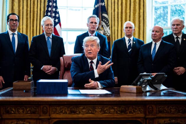 President Donald Trump participates in a signing ceremony for a two trillion dollar coronavirus relief bill in the Oval Office at the White House in Washington, DC on March 27, 2020. The economic stimulus package, the largest in U.S. history, provides economic bailouts to companies, independent contractors and includes direct payments to individuals as the U.S. suffers from the COVID-19 pandemic.  WAX20200327407 ERINxSCHAFF