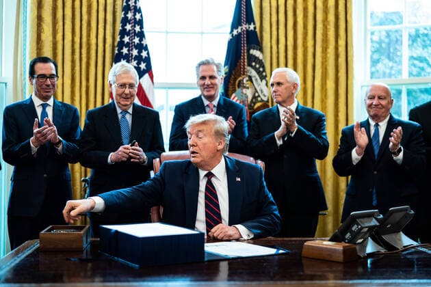 President Donald Trump participates in a signing ceremony for a two trillion dollar coronavirus relief bill in the Oval Office at the White House in Washington, DC on March 27, 2020. The economic stimulus package, the largest in U.S. history, provides economic bailouts to companies, independent contractors and includes direct payments to individuals as the U.S. suffers from the COVID-19 pandemic.  WAX20200327418 ERINxSCHAFF