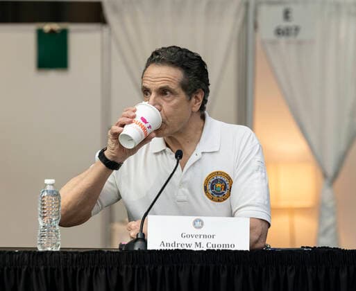 NY: Andrew Cuomo addresses National Guard members Governor Andrew Cuomo drinks Dunkin coffee during address National Guard members and media praising complition of makeshift hospitals at Jacob Javits Center New York New York United States Copyright: LevxRadin