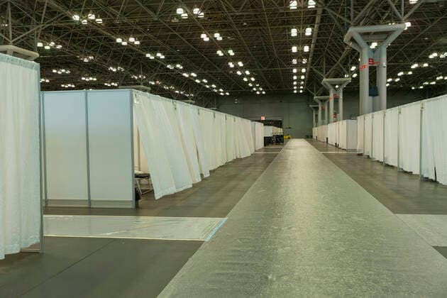NY: Andrew Cuomo addresses National Guard members View of row makeshift hospital rooms built by National Guard members at Jacob Javits Center New York New York United States Copyright: LevxRadin