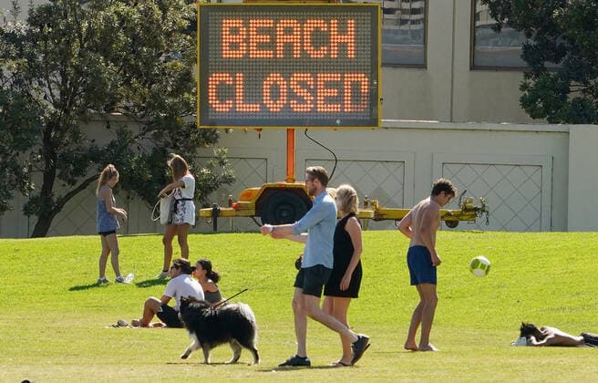 AUSTRALIA CORONAVIRUS COVID-19, People sunbathe at St Kilda Beach in Melbourne, Saturday, March 28, 2020. Port Phillip City Council has clamped down on large groups accessing all of its beaches including the popular St Kilda Beach. A shutdown of non-essential services is in effect Australia wide in a bid to slow the spread of the coronavirus (COVID-19) disease. ( NO ARCHIVING, EDITORIAL USE ONLY, NO USE IN BOOKS WITHOUT CONSENT MELBOURNE VIC AUSTRALIA  Copyright: xSCOTTxBARBOURx 20200328001460556970