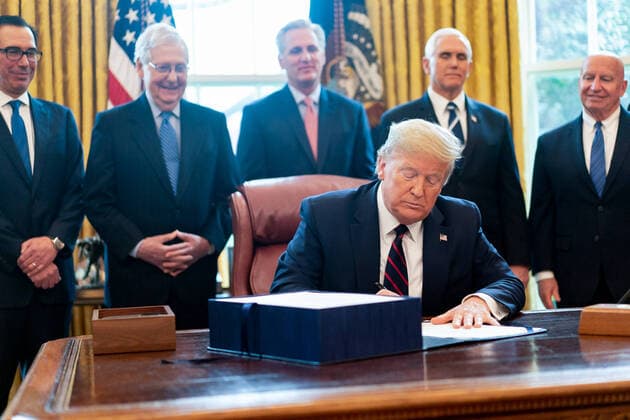 March 27, 2020, Washington, The District of Columbia, United States Of America: President Donald J. Trump signs the Ã’Coronavirus Aid, Relief, and Economic Security (CARES) Act,O a $2.2 trillion emergency assistance bill in response to the coronavirus pandemic Friday, March 27, 2020, in the Oval Office of the White House...People: President Donald J. Trump. Washington United States Of America - ZUMAs214 20200327_zaa_s214_002 Copyright: xSMGx