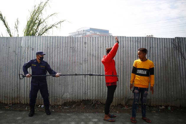 March 28, 2020, Kathmandu, Nepal: A policeman arresting a lockdown violator using a multifunctional device that lets him maintain social distance on the fifth day of government imposed nationwide lockdown amid concerns over the coronavirus pandemic in Kathmandu, Nepal on Saturday, March 28, 2020. Kathmandu Nepal - ZUMAg200 20200328_zap_g200_002 Copyright: xSkandaxGautamx