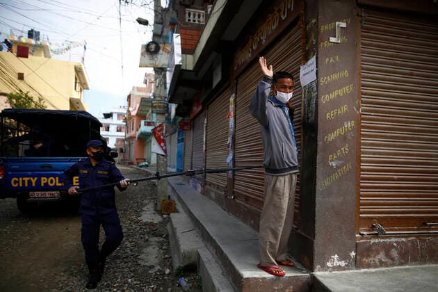 March 28, 2020, Kathmandu, Nepal: A policeman arresting a lockdown violator using a multifunctional device that lets him maintain social distance on the fifth day of government imposed nationwide lockdown amid concerns over the coronavirus pandemic in Kathmandu, Nepal on Saturday, March 28, 2020. Kathmandu Nepal - ZUMAg200 20200328_zap_g200_005 Copyright: xSkandaxGautamx