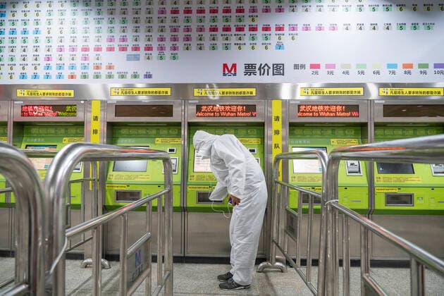 (200328) -- WUHAN, March 28, 2020 -- A passenger buys a ticket from a ticket vending machine at the metro station of Wuchang Railway Station in Wuhan, central China s Hubei Province, March 28, 2020. Six metro lines in Wuhan resumed operation starting from Saturday, a new sign that life is gradually returning to normal in the hardest-hit city. Passengers are required to scan the QR code for real-name registration and take temperature checks before taking the subway. Each train is equipped with a train safety crew member to help guide and serve the passengers. ) CHINA-HUBEI-WUHAN-METRO-OPERATION RESTORATION (CN) CaixYang 