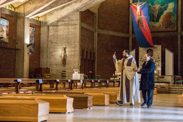 Seriate. Bergamo. Blessing of 90 bodies by Don Marcello Crotti parish priest of the church of San Giuseppe in Seriate waiting place before cremation of people who died as a result of COVID19 Coronavirus (Carlo Cozzoli Fotogramma, Seriate - 2020-03-28) p.s. la foto e utilizzabile nel rispetto del contesto in cui e stata scattata, e senza intento diffamatorio del decoro delle persone rappresentate  Copyright: xCarloxCozzolix xFOTOGRAMMAx