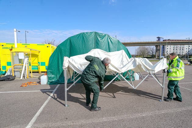 BRITAIN VIRUS OUTBREAK - NHS Support Unit personnel is seen setting up medical support hardware equipment at the ExCel Centre in London on Saturday, March 28, 2020. NHS Nightingale makeshift hospital is being made into a temporary 4000-bed, comprising of two wards, each of 2,000 people, to help tackle the coronavirus outbreak in Britain. (Photo Vudi Xhymshiti)  iMagoVX