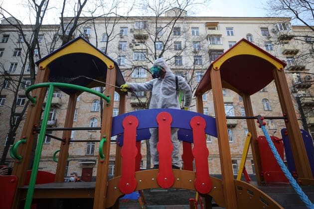 MOSCOW, RUSSIA - MARCH 28, 2020: A sanitary worker in a protective suit disinfects a children s playground in a residential area of Moscow. Since 5 March, Moscow has been on high alert in connection with the pandemic of the novel coronavirus (COVID-19). Streets and other public areas are cleaned and disinfected to counter the spread of the novel coronavirus. As of 28 March 2020, Russia has reported more than 1200 confirmed cases of the novel coronavirus (COVID-19), with more than 800 confirmed cases in Moscow. Sergei Bobylev TASS  TS0D3B1E