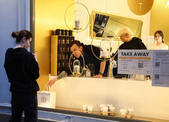 MOSCOW, RUSSIA - MARCH 28, 2020: A woman receives her takeaway order amid the ongoing COVID-19 pandemic. According to a decree by Moscow Mayor Sergei Sobyanin, from 28 March to 5 April 2020, all restaurants, cafes, bars, and other eating establishments must shut down, except for delivery and take-away services with no customers visiting their premises. Valery Sharifulin TASS  TS0D3B80