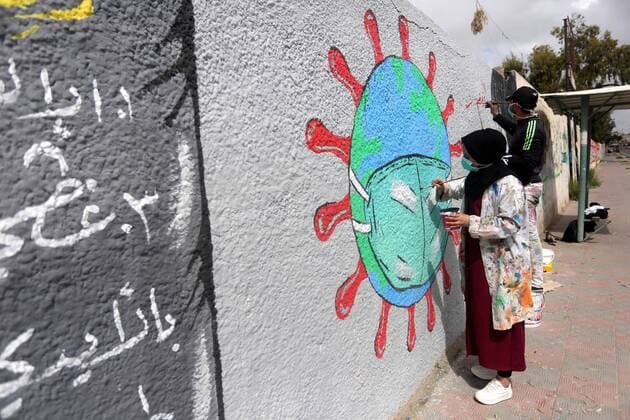 March 28, 2020, Khan Younis, Gaza Strip, Palestinian Territory: Palestinian artists draw a mural during awareness campaign about the coronavirus COVID-19, in Khan Younis in the southern of Gaza Strip on March 28, 2020 Khan Younis Palestinian Territory - ZUMAap3_ 20200328_zaf_ap3_028 Copyright: xAshrafxAmrax